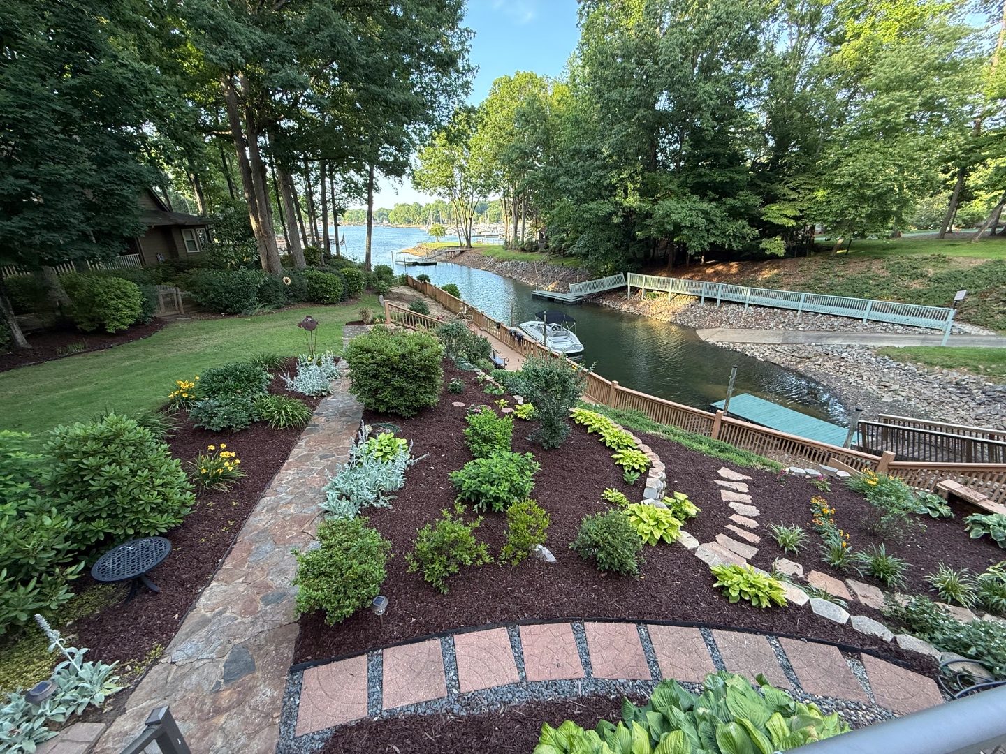 Mulched garden beds and stone path installed by Andrew's Landscaping